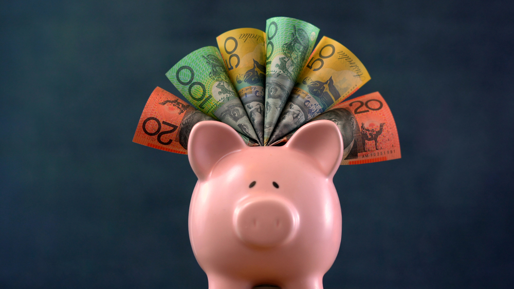 Pink piggy bank with Australian dollar banknotes fanned out from the top, representing superannuation savings for a Hunter Valley client