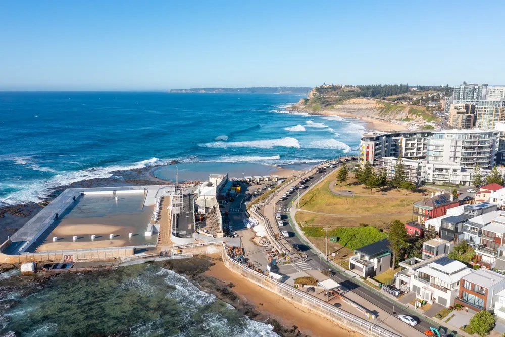 Aerial view of Newcastle coastline with the ocean baths, beach and headland