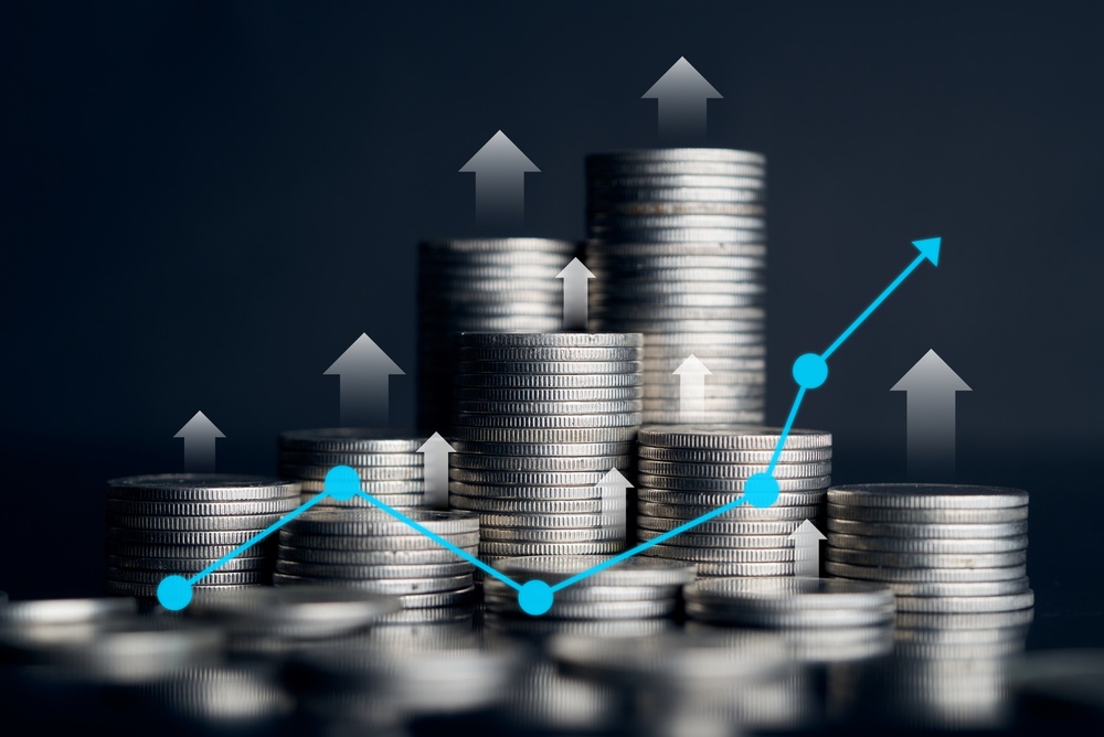 Rising stacks of silver coins with upward arrows and a blue line graph overlay, illustrating portfolio growth for a Lake Macquarie investment client