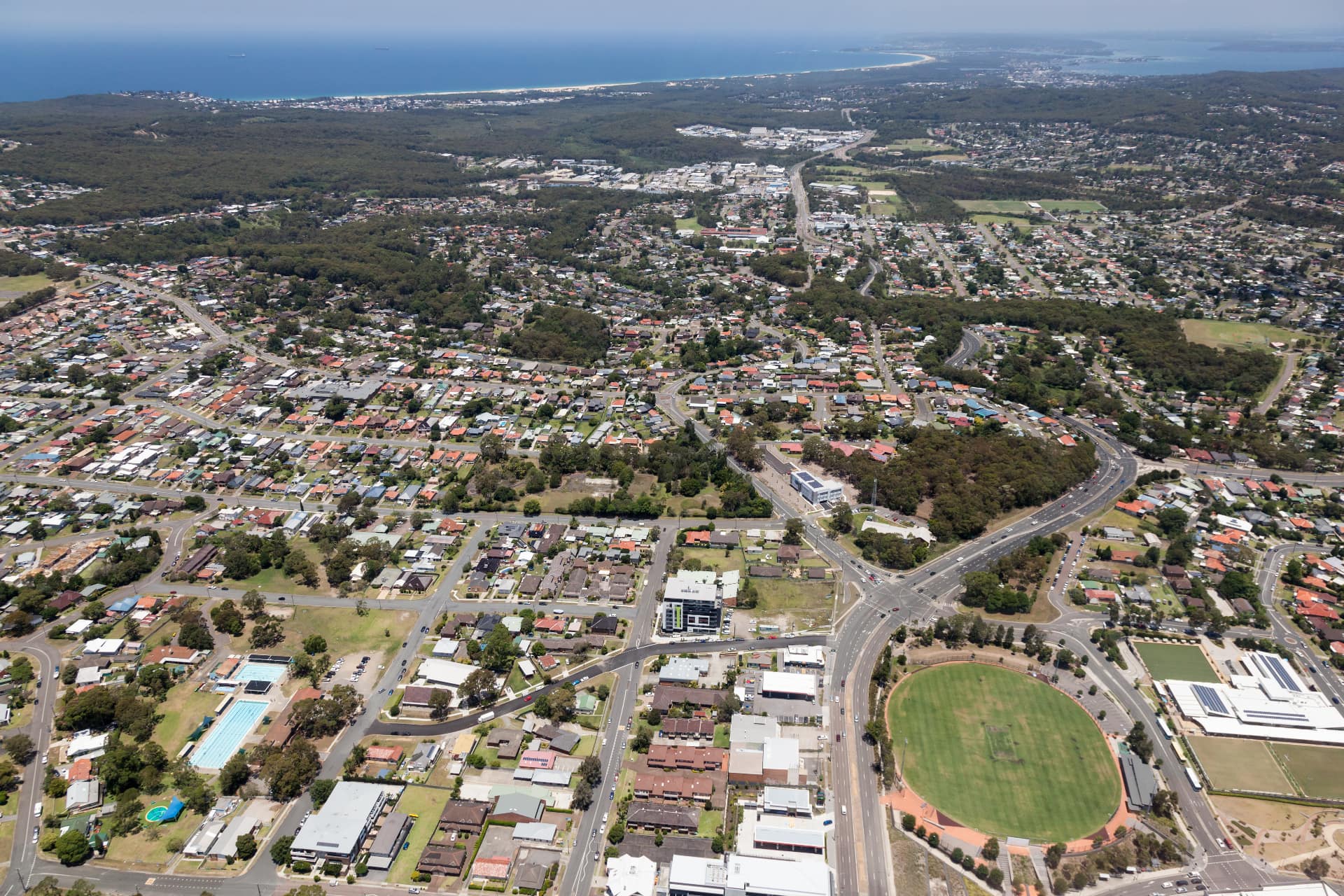 Aerial view of Hunter region suburbs, sports oval and coastline served by Newburn Wealth Advisory financial advisers