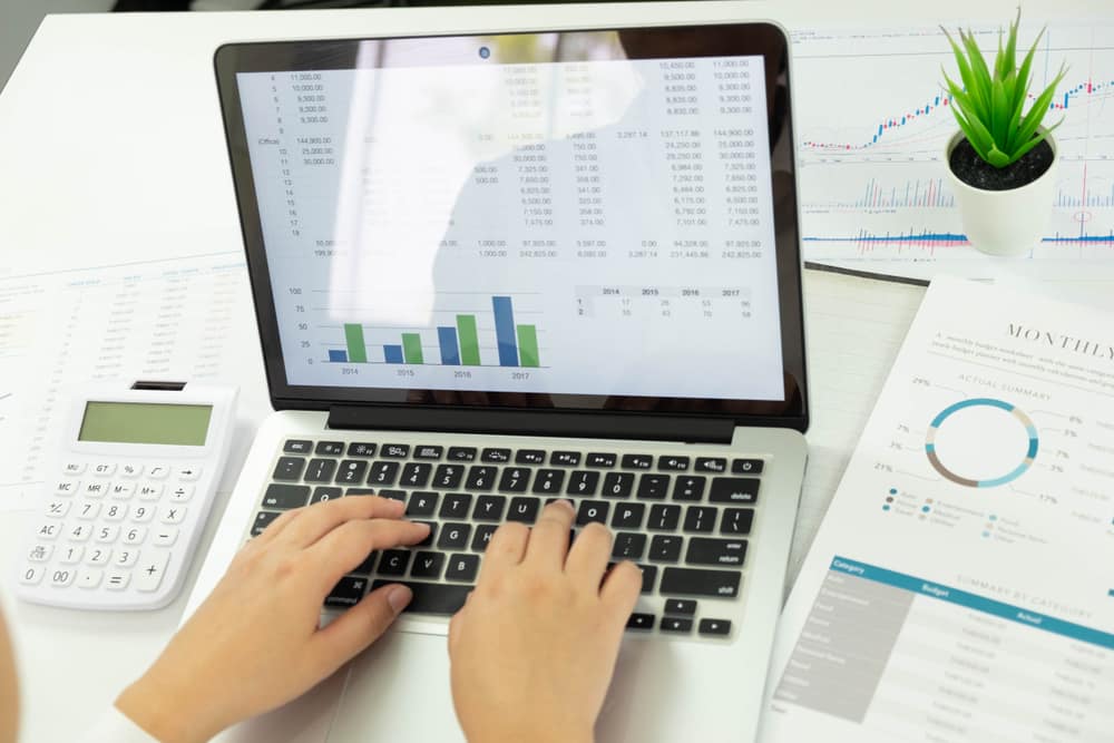 Bar chart on a laptop screen showing investment portfolio performance for a Hunter region client